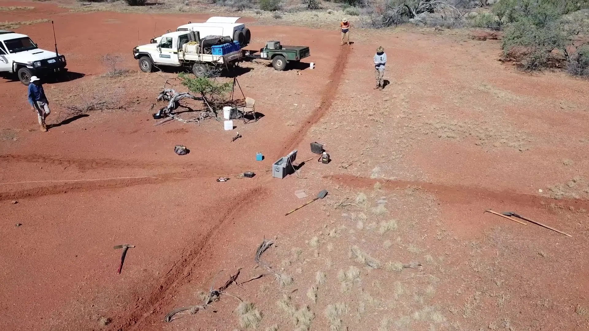 Researchers conducting fieldwork with survey equipment in the Australian outback, from the 2026 AuScope film